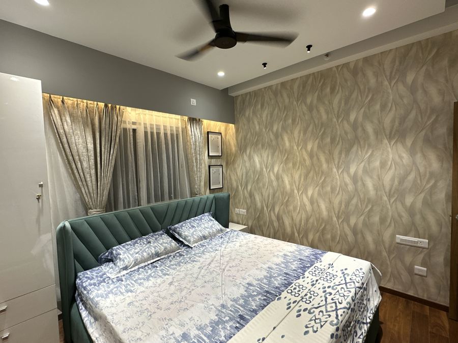 Bedroom with a textured wave-pattern wallpaper accent wall